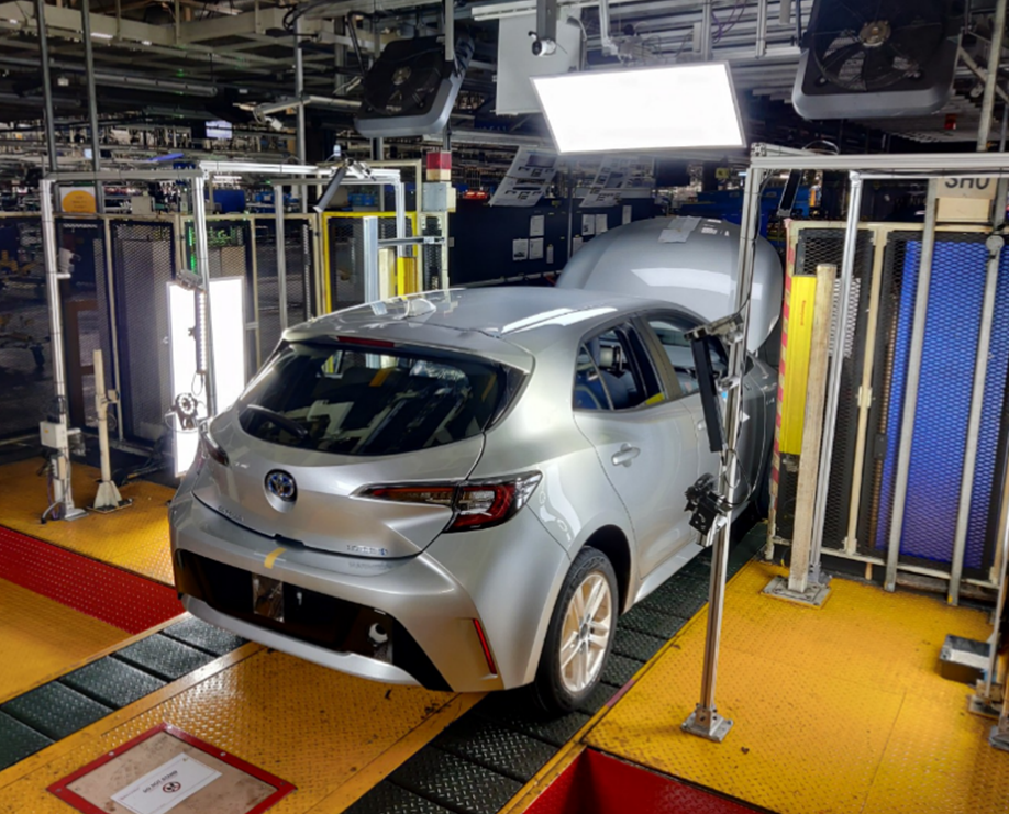 A vehicle being automatically inspected in Toyota's manufacturing plant